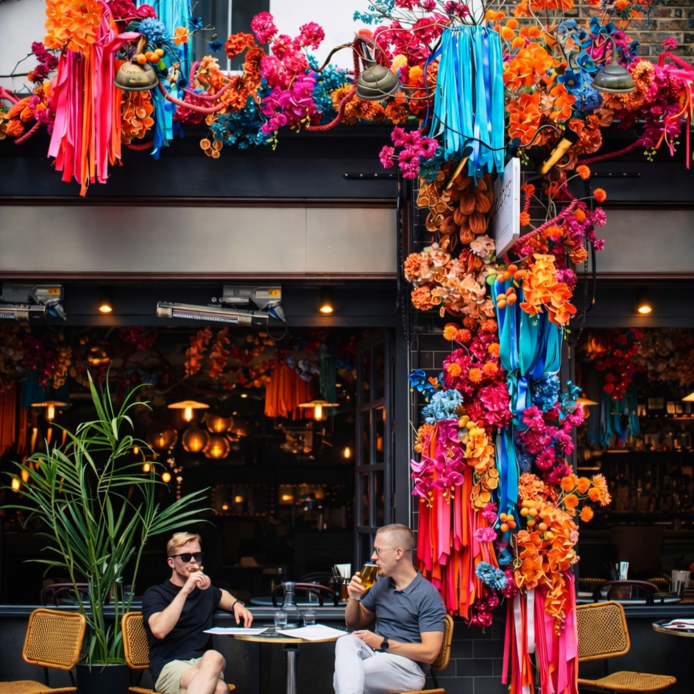 Colorful floral decorations adorn famous london restaurant as impressive installation