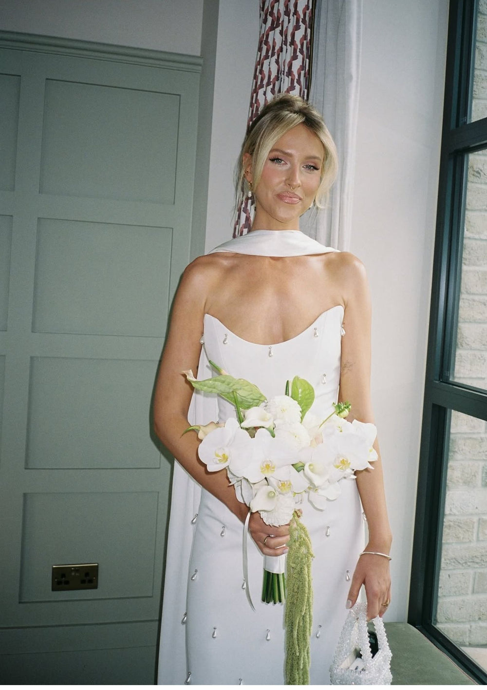 Bride in a white dress holding a bouquet of  bridal flowers